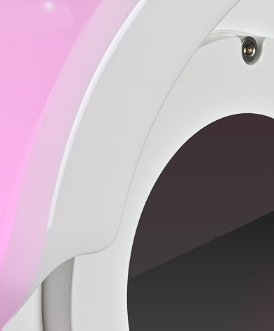 A close up of a pink and white toilet seat.